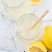 Top view of a glass of lemonade with ice cubes in it