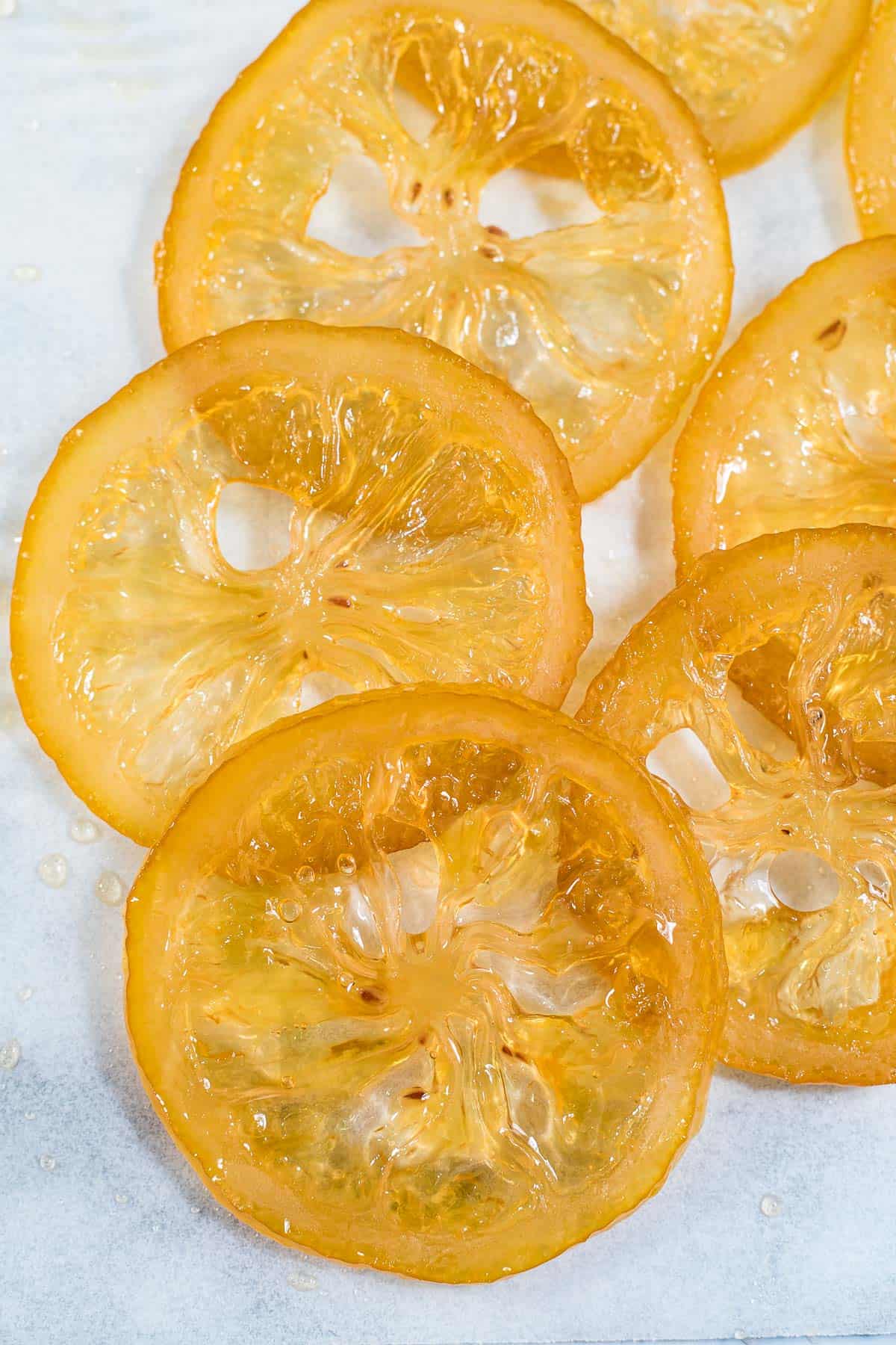 Close up of candied lemon slices against a marble background
