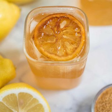Top view of a glass of brown sugar lemonade with caramelized lemon slice