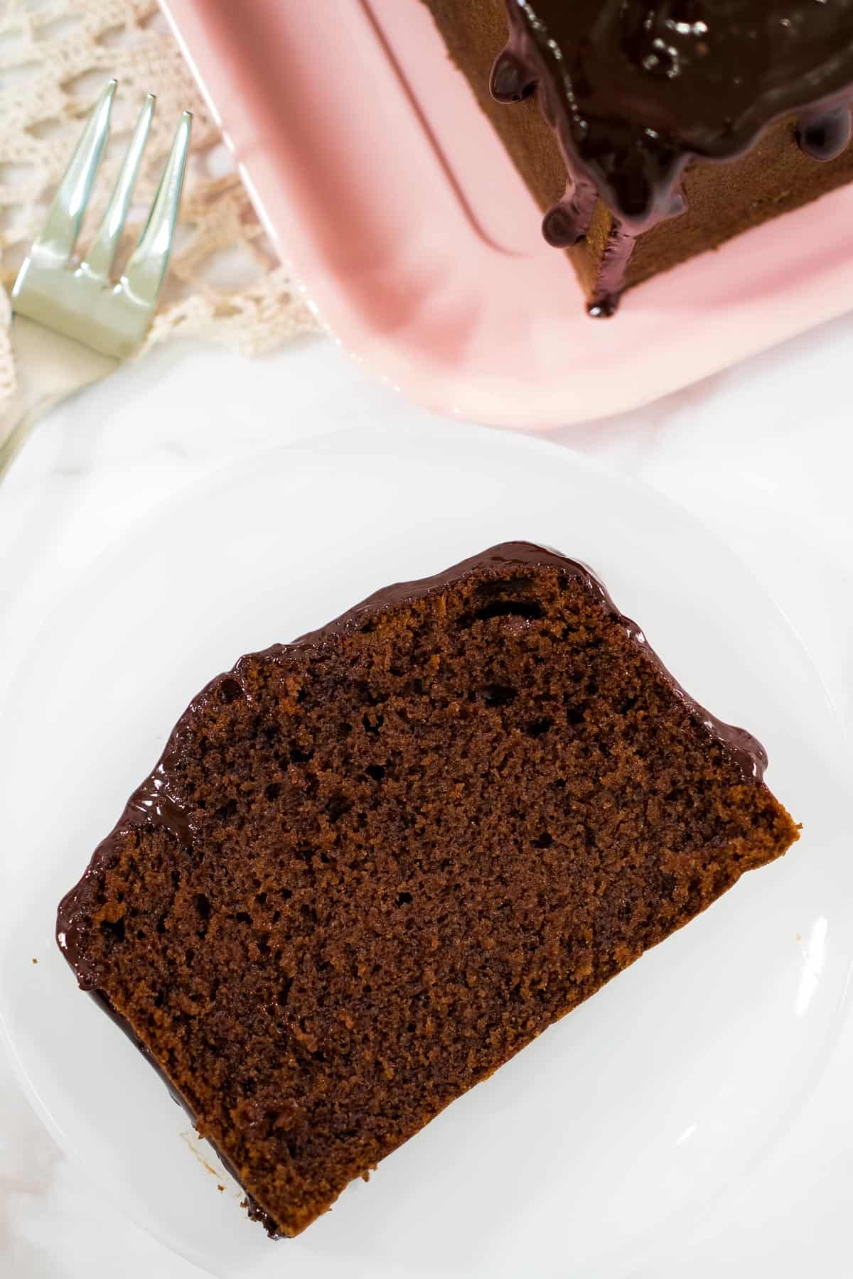 A slice of chocolate cake on a white plate