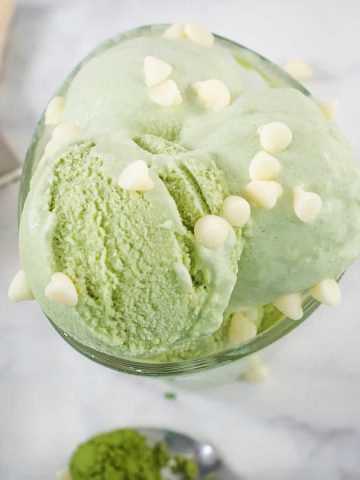 Top view of a small glass of green ice cream with while chocolate chips