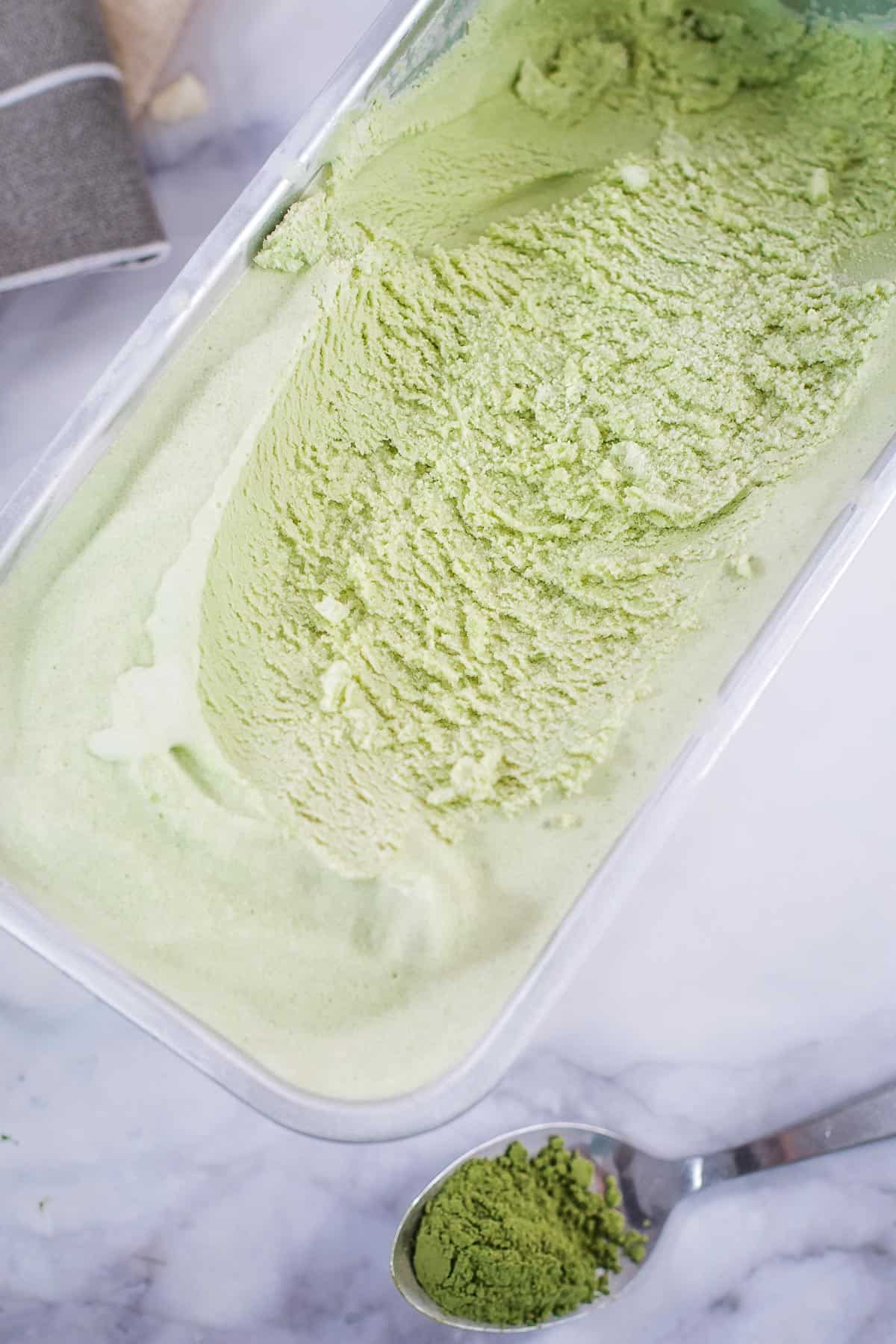 An ice cream tub with matcha ice cream.