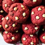 A pile of red velvet cookies with chocolate chips.