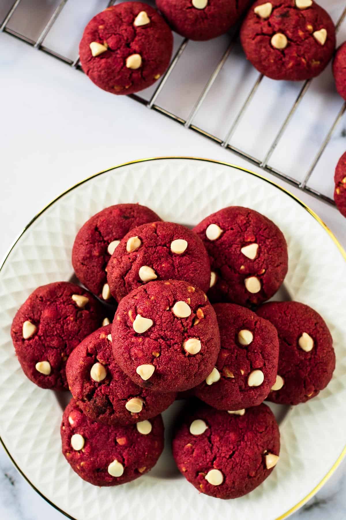 Red cookies on a white plate.