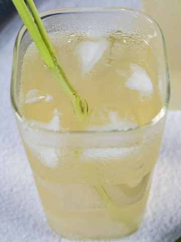 A glass of iced drink with ice cubes