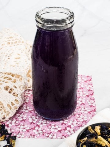 Blue butterfly pea syrup in a bottle.