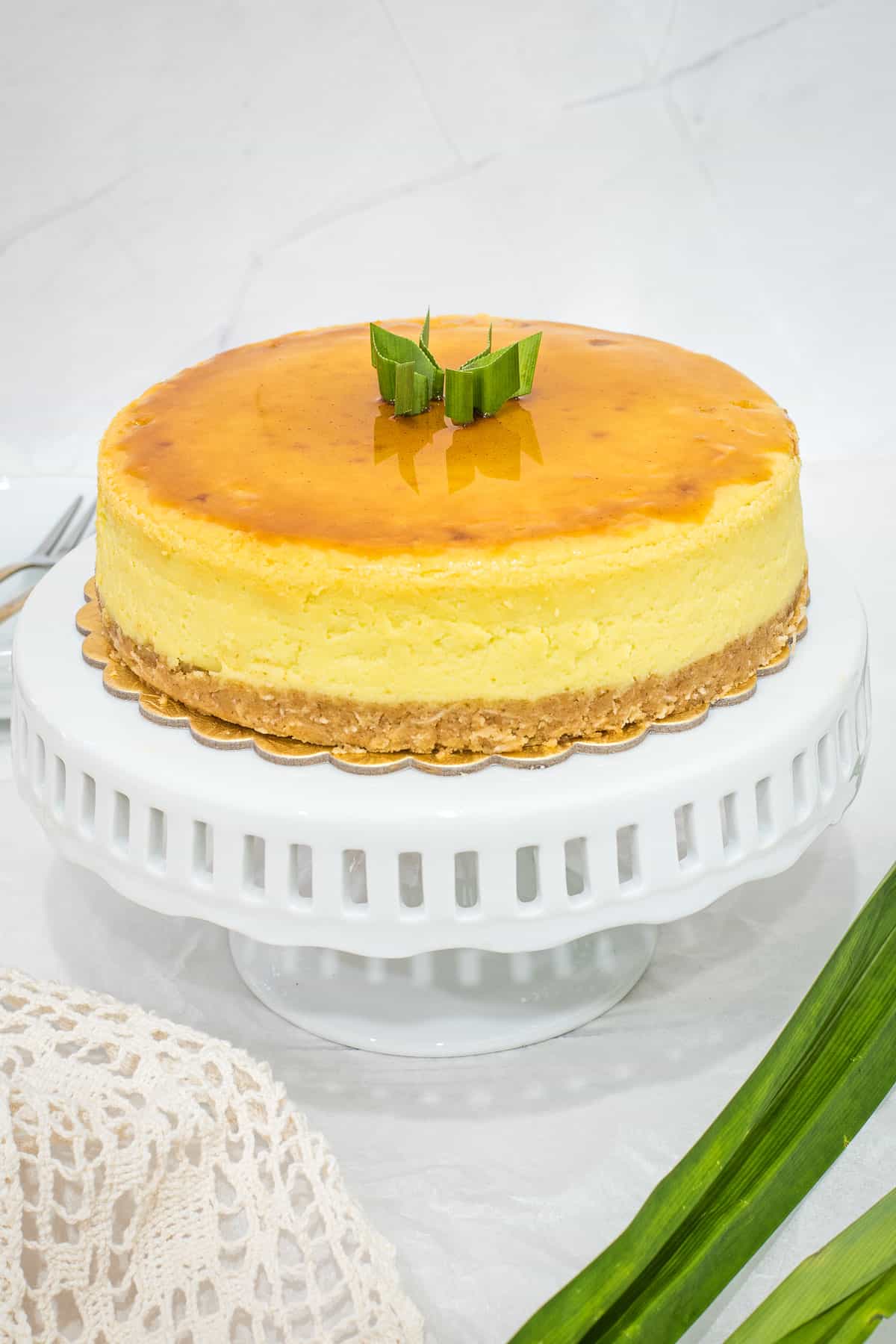A round cake on a white cake stand.