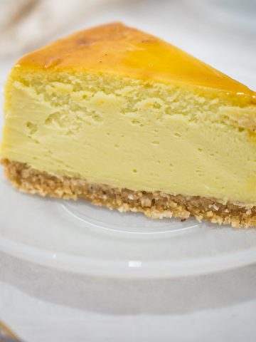 A slice of pandan cheesecake on a white plate.
