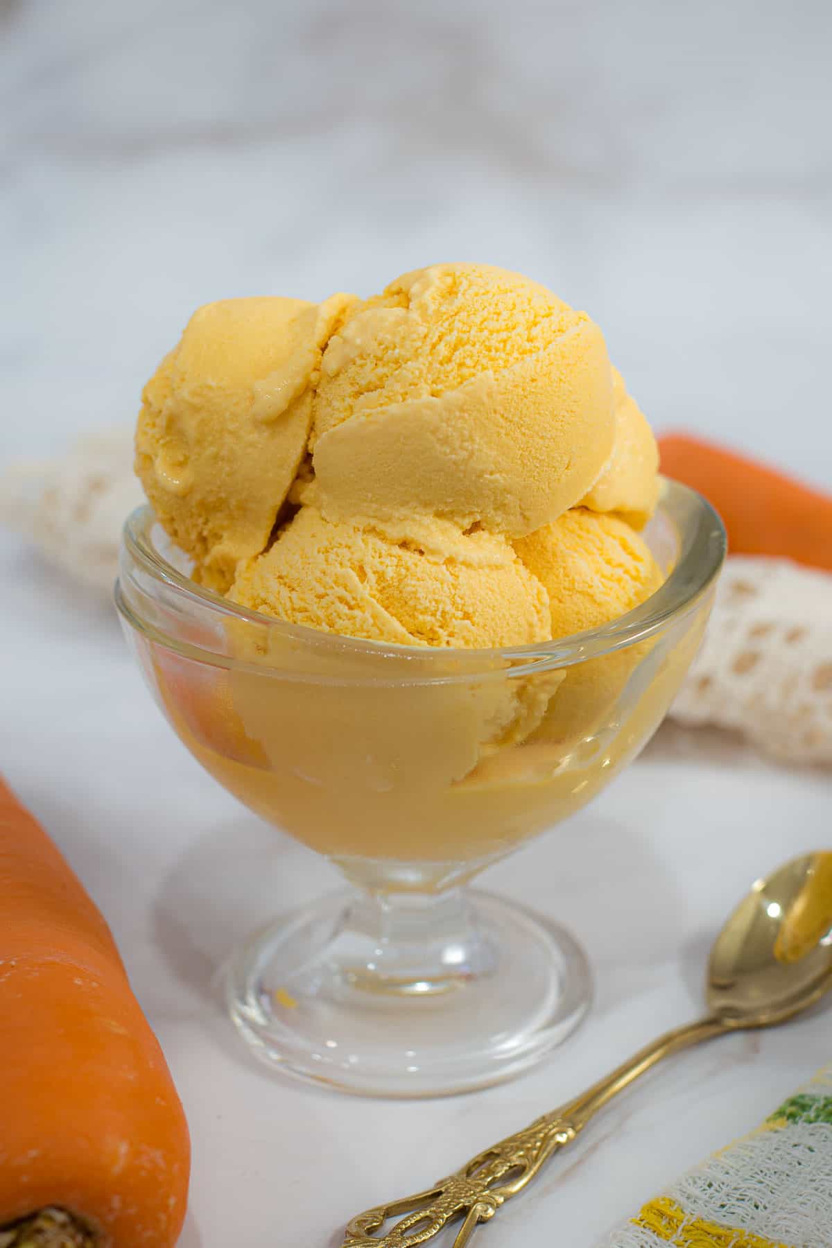 Scoops of carrot ice in a bowl.