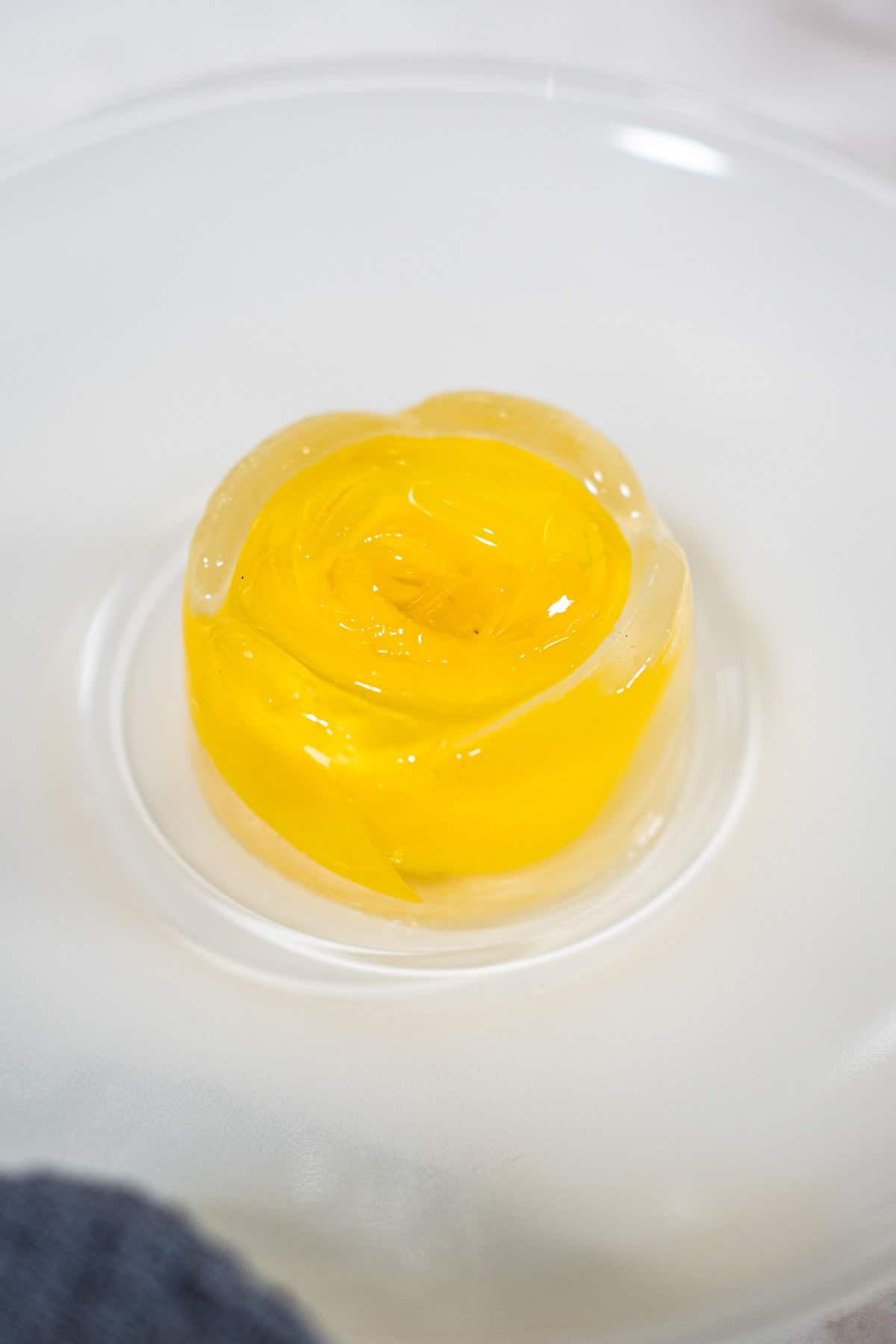 Rose shaped jelly on a white plate.