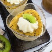 Top view of a cup of mousse with a slice of kiwi on top.