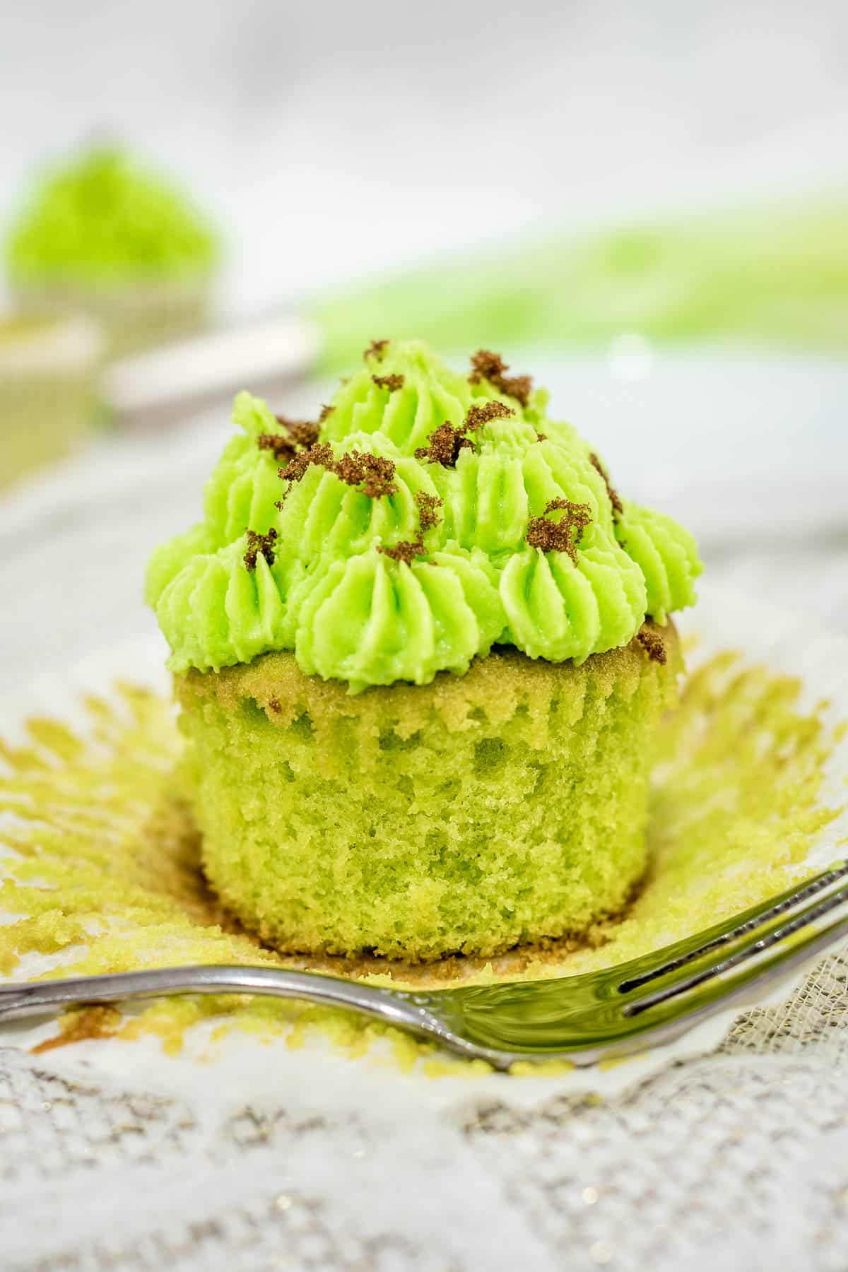 A green cupcake with its casing open.
