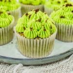 A few green cupcakes on a grey plate.