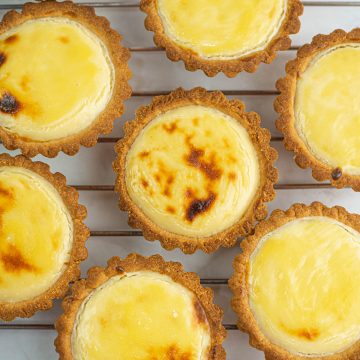 Top view of cheese tarts on a wire rack.