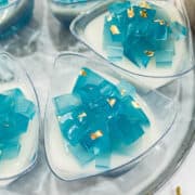 Top view of jelly cups with white jelly and blue cubed jelly topping.