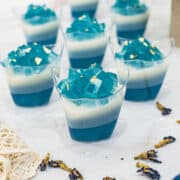 7 cups and blue and white layered jelly.