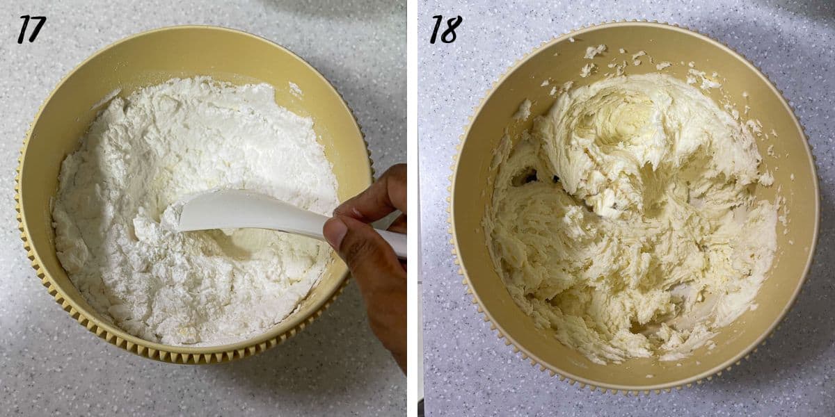 Mixing powdered sugar in a bowl by hand, with a spatula and creamed frosting in a bowl.