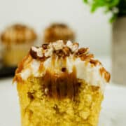 A cupcake with caramel filling cut into half.