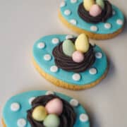 3 egg shaped cookies with 3d nests and eggs toppers.