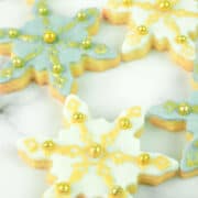 Blue and white snowflake cookies decorated in gold.