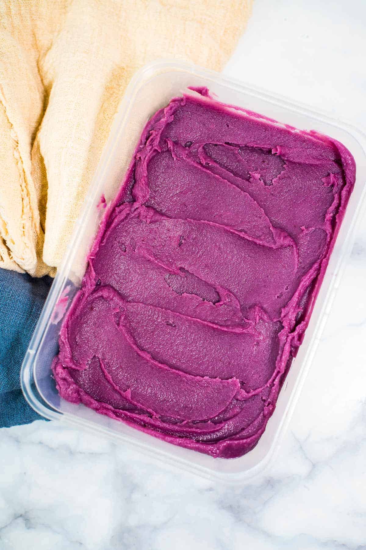A rectangle container of purple yam jam.