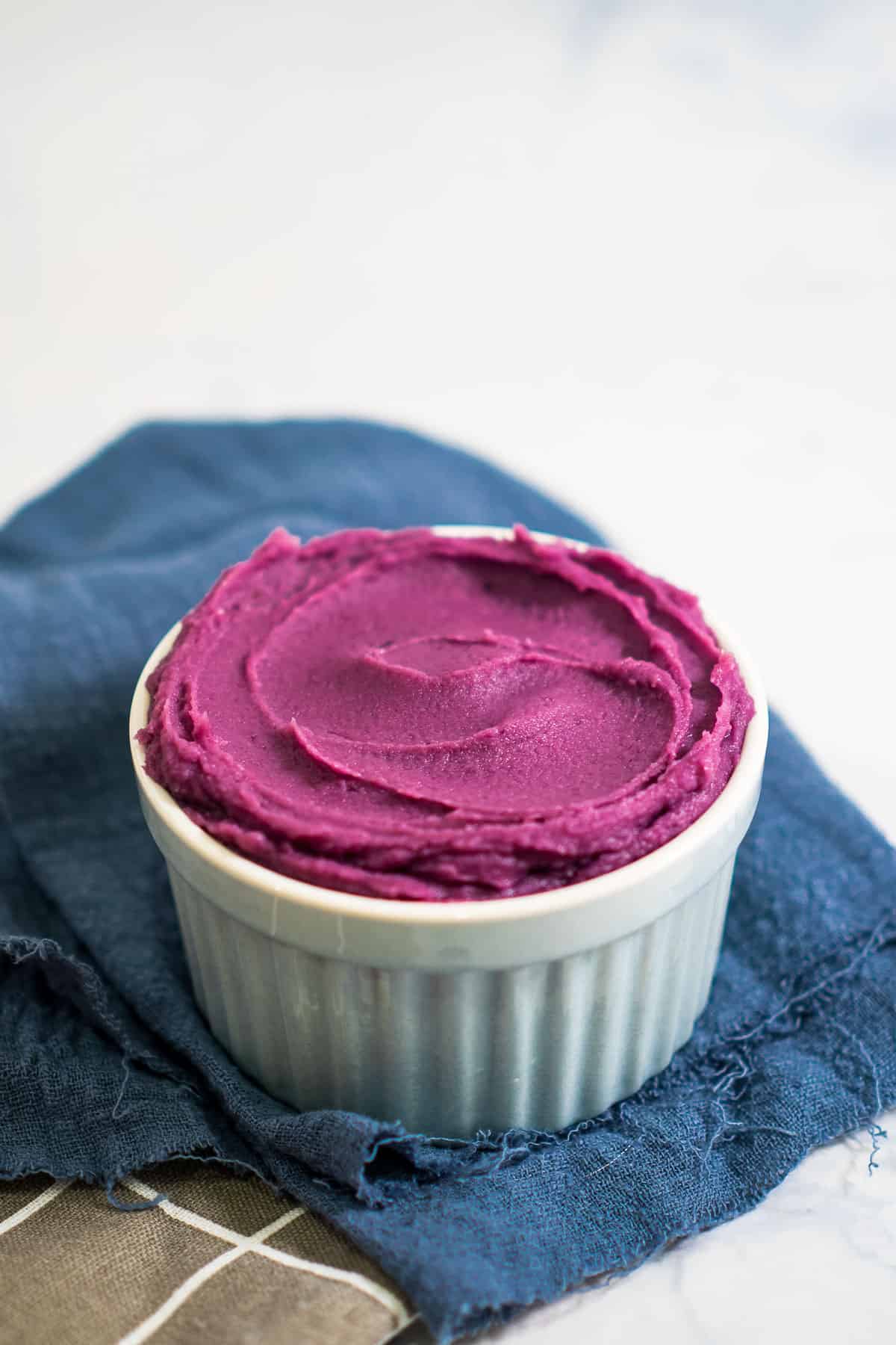 A white bowl of purple jam.
