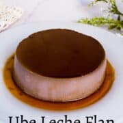 Round ube leche flan on a white plate.