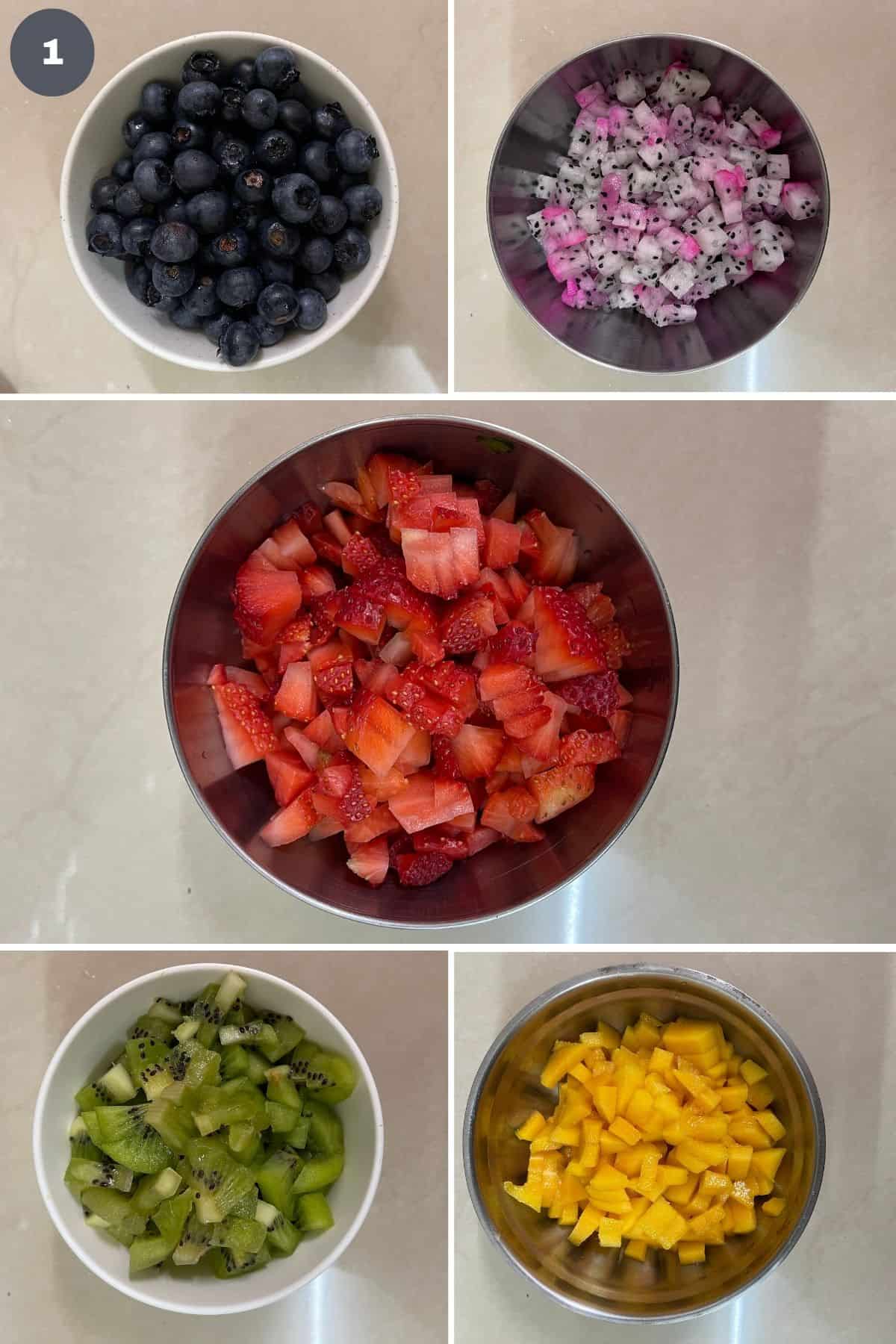 Separate bowls of blueberries, chopped dragon fruit, chopped strawberries, chopped kiwi and chopped mango.
