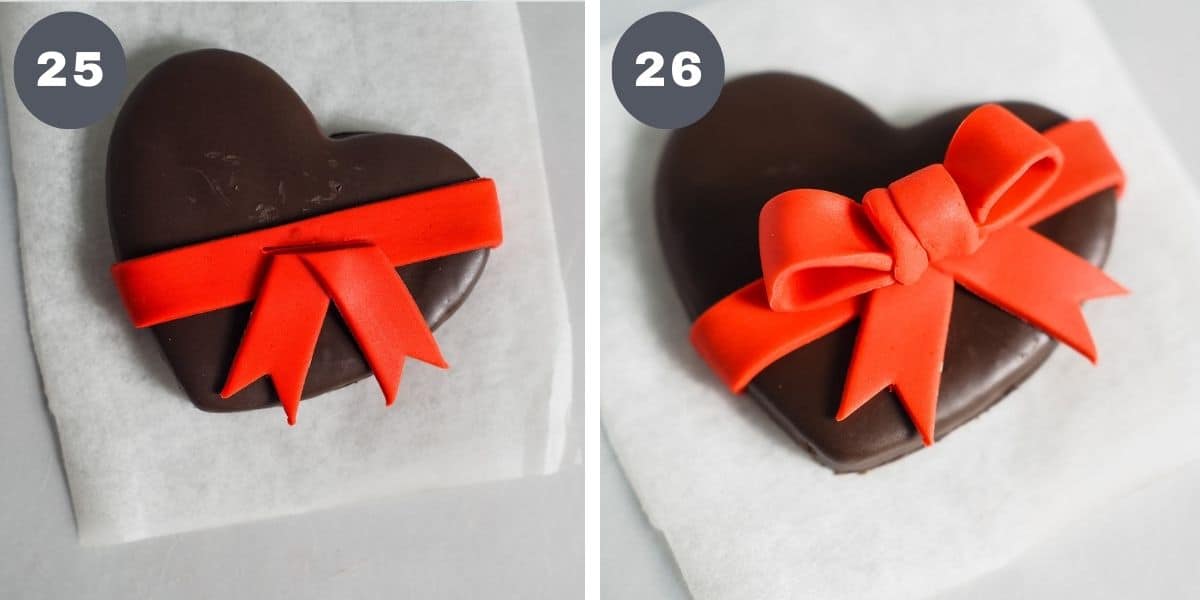Decorating chocolate heart cookies with red fondant bow.