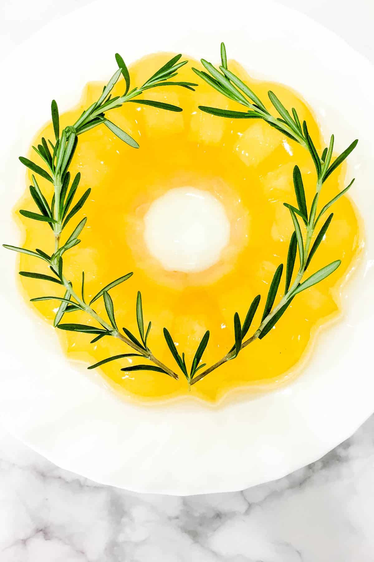 Yellow jelly on a white plate.