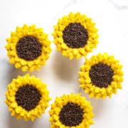5 cupcakes with yellow petals and chocolate sprinkle centers.