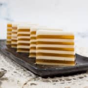 Coconut jelly with gula melaka layers on a brown plate.